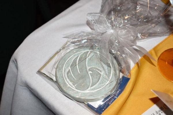 Ornament with black hawk college logo on a table